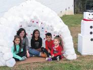 children in a fake igloo